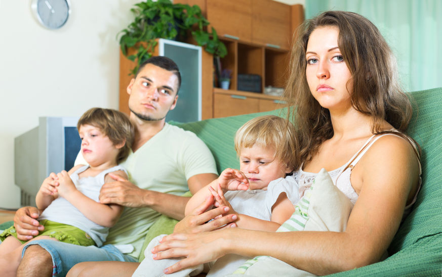 42204631 - depressed parents after an argument with children in their arms