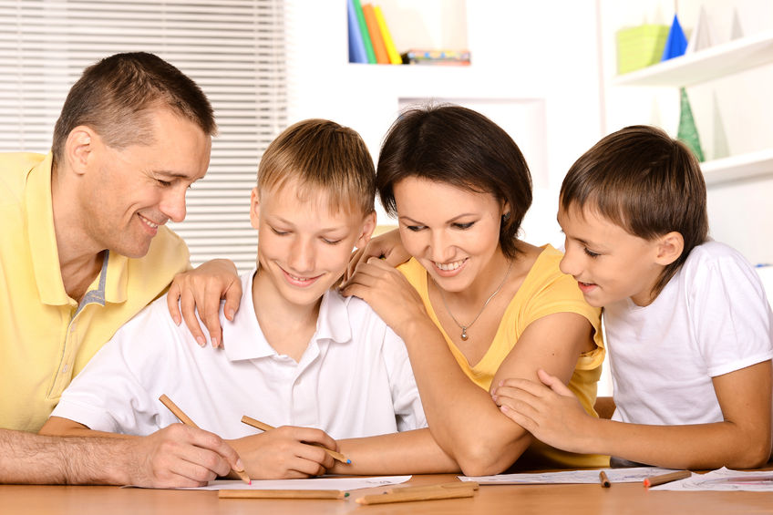 38768579 - happy family drawing at the table together