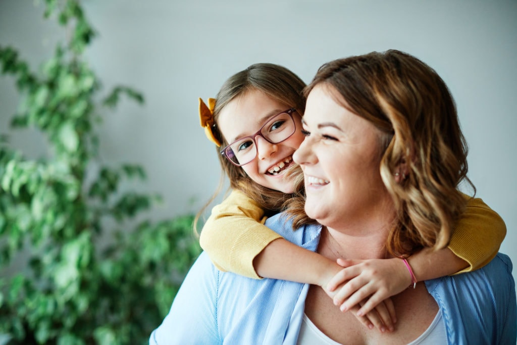 mother and daughter playing and having fun at home
