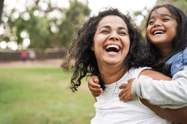 Happy mother having fun with her daughter outdoor - Family and love concept - Focus on mum face